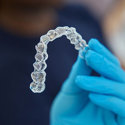 Woman inserting Invisalign clear aligner