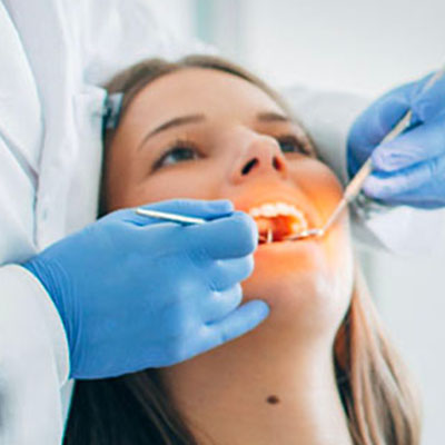 Woman undergoing teeth whitening procedure